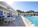 Refreshing community pool with a covered patio and seating at 1815 Vera Pl # 9, Sarasota, FL 34235