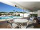 Community pool with patio furniture and covered seating area at 1815 Vera Pl # 9, Sarasota, FL 34235