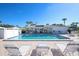 Relaxing community pool with surrounding lounge chairs at 1815 Vera Pl # 9, Sarasota, FL 34235