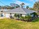 Single-story home with teal accents, gray roof, and large yard at 2022 Riverside E Dr, Bradenton, FL 34208