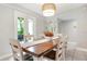 Bright dining room with wooden table and access to backyard at 2202 Hyde Park St, Sarasota, FL 34239