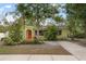 Bright yellow house with red door and a spacious yard at 2202 Hyde Park St, Sarasota, FL 34239
