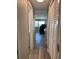 Bright hallway with wood-look floors, leading to living area and closets at 2601 Gulf N Dr # 631, Bradenton Beach, FL 34217