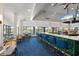 Modern bar with green tile and blue barstools at 26720 Weiskopf Dr, Englewood, FL 34223