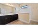 Elegant bathroom featuring double vanity and a walk-in shower at 26720 Weiskopf Dr, Englewood, FL 34223