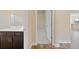 Small bathroom with dark vanity and view into another room at 26720 Weiskopf Dr, Englewood, FL 34223