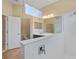 Bright bathroom with double sinks, shower, and tile floors at 26720 Weiskopf Dr, Englewood, FL 34223