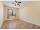 Bedroom with tile floors, ceiling fan and window coverings at 26720 Weiskopf Dr, Englewood, FL 34223