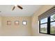 Bedroom with multiple windows, a ceiling fan and neutral colored walls at 26720 Weiskopf Dr, Englewood, FL 34223
