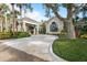 Inviting clubhouse entrance with landscaping and porte cochere at 26720 Weiskopf Dr, Englewood, FL 34223