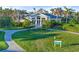 Resort clubhouse with lush landscaping and a welcoming entrance at 26720 Weiskopf Dr, Englewood, FL 34223