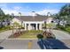 Community clubhouse with welcoming entrance and landscaping at 26720 Weiskopf Dr, Englewood, FL 34223