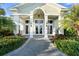 Elegant clubhouse entrance with landscaping at 26720 Weiskopf Dr, Englewood, FL 34223