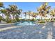 Resort-style pool with palm trees and lounge chairs at 26720 Weiskopf Dr, Englewood, FL 34223