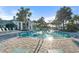 Resort-style pool with lounge chairs and palm trees at 26720 Weiskopf Dr, Englewood, FL 34223