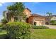 House exterior with landscaping, driveway and tile roof at 26720 Weiskopf Dr, Englewood, FL 34223