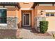 Inviting entryway with stone detailing and a double door at 26720 Weiskopf Dr, Englewood, FL 34223