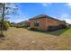 Back exterior view of a single-Gathering house with landscaping at 26720 Weiskopf Dr, Englewood, FL 34223