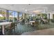 Elegant indoor dining area with large windows and golf course views at 26720 Weiskopf Dr, Englewood, FL 34223