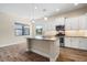 Modern kitchen featuring island, stainless steel appliances, and white cabinets at 26720 Weiskopf Dr, Englewood, FL 34223