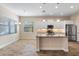 Modern kitchen with white cabinets, stainless steel appliances, and an island at 26720 Weiskopf Dr, Englewood, FL 34223