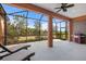 Relaxing screened porch with lounge chairs and grill at 26720 Weiskopf Dr, Englewood, FL 34223