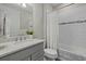 Bathroom with single vanity, shower/tub combo, and gray cabinets at 3314 Chestertown Loop, Bradenton, FL 34211