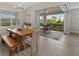 Elegant dining room with a large wooden table and access to a patio at 3314 Chestertown Loop, Bradenton, FL 34211