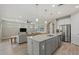 Open kitchen with large island, stainless steel appliances, and gray cabinets at 3314 Chestertown Loop, Bradenton, FL 34211