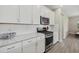 Modern kitchen with stainless steel appliances and white cabinetry at 3314 Chestertown Loop, Bradenton, FL 34211