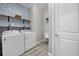 Laundry room with washer, dryer, and stylish wave wallpaper at 3314 Chestertown Loop, Bradenton, FL 34211