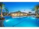 Community pool with a clubhouse and lush tropical landscaping at 3314 Chestertown Loop, Bradenton, FL 34211