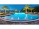 Stunning resort-style pool at night with relaxing seating areas at 3314 Chestertown Loop, Bradenton, FL 34211