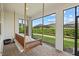 Screened porch with hanging swing bed, offering a tranquil outdoor space at 3314 Chestertown Loop, Bradenton, FL 34211