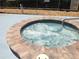 Round community hot tub with brick border at 3333 26Th E Ave # 1120, Bradenton, FL 34208