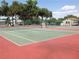 Two community tennis courts with red and green surface at 3333 26Th E Ave # 1120, Bradenton, FL 34208