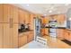 Bright kitchen featuring wood cabinets, stainless steel appliances, and granite countertops at 3443 Tallywood Cir # 7061, Sarasota, FL 34237