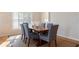 Casual dining area with wood table and blue patterned chairs, bathed in natural light at 3455 Byron Ln, Longboat Key, FL 34228