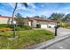 Front view of a two-story house with a spacious yard and mature trees at 3709 Miguel Way # 8602, Sarasota, FL 34232