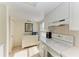 Bright white kitchen features white appliances and ample counter space at 3810 W 75Th St # 101, Bradenton, FL 34209