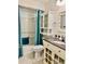 Bathroom with teal shower curtain and updated vanity at 4127 3Rd Ave W, Palmetto, FL 34221