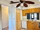 Kitchen boasts wood cabinets, a double sink, and built-in microwave at 4127 3Rd Ave W, Palmetto, FL 34221