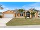 Attractive single-story house featuring a light orange exterior and a screened porch at 433 Scarlet Sage, Punta Gorda, FL 33955