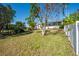 Spacious backyard with grassy lawn and partial view of neighboring home at 4419 Mangrove Point Rd, Bradenton, FL 34210