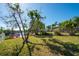 Landscaped backyard with canal views and seating area at 4419 Mangrove Point Rd, Bradenton, FL 34210