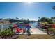 Private dock with colorful chairs, overlooking a tranquil waterway at 4419 Mangrove Point Rd, Bradenton, FL 34210