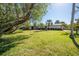 House exterior with lush landscaping and large trees at 4419 Mangrove Point Rd, Bradenton, FL 34210