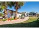 Home's side yard with patio and lush landscaping at 4419 Mangrove Point Rd, Bradenton, FL 34210