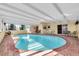 Relaxing kidney-shaped pool with a covered patio and seating area at 4419 Mangrove Point Rd, Bradenton, FL 34210