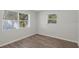 Bedroom with wood flooring and two windows at 4485 17Th W St, Bradenton, FL 34207